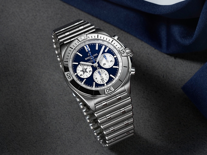 Limited edition Dallas Cowboys Chronomat with a silver bracelet and a dark blue dial.