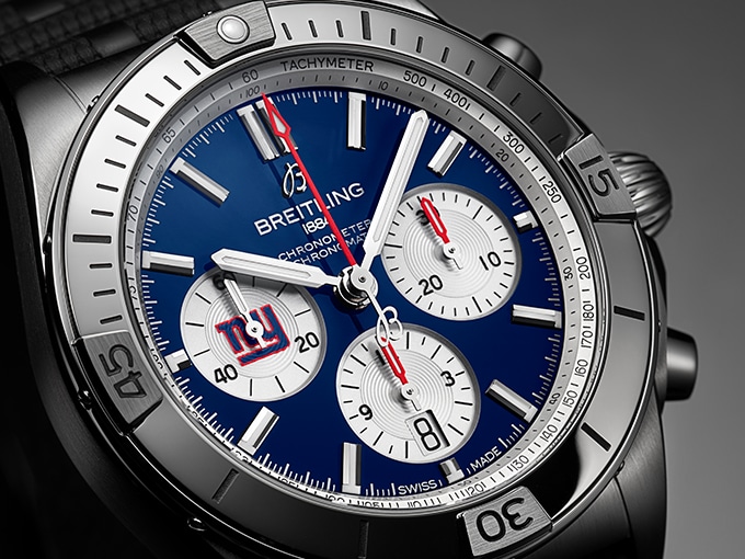 Close-up of the limited edition New York Giants Chronomat with a dark dial and silver case.