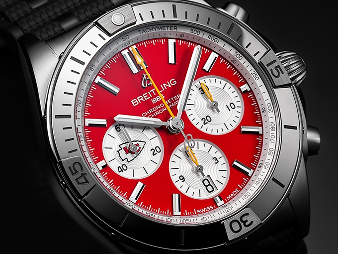 The Chronomat B01 42 NFL Kansas Chiefs Edition with a red dial and a stainless steel case.