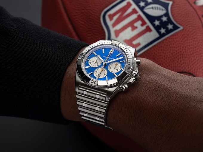 The Chronomat B01 42 NFL Los Angeles Chargers Edition with a blue dial on a male wrist.