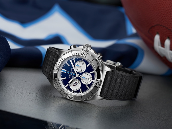 The Chronomat NFL Tennesee Titans Edition with a dark blue dial and a jersey in the background.